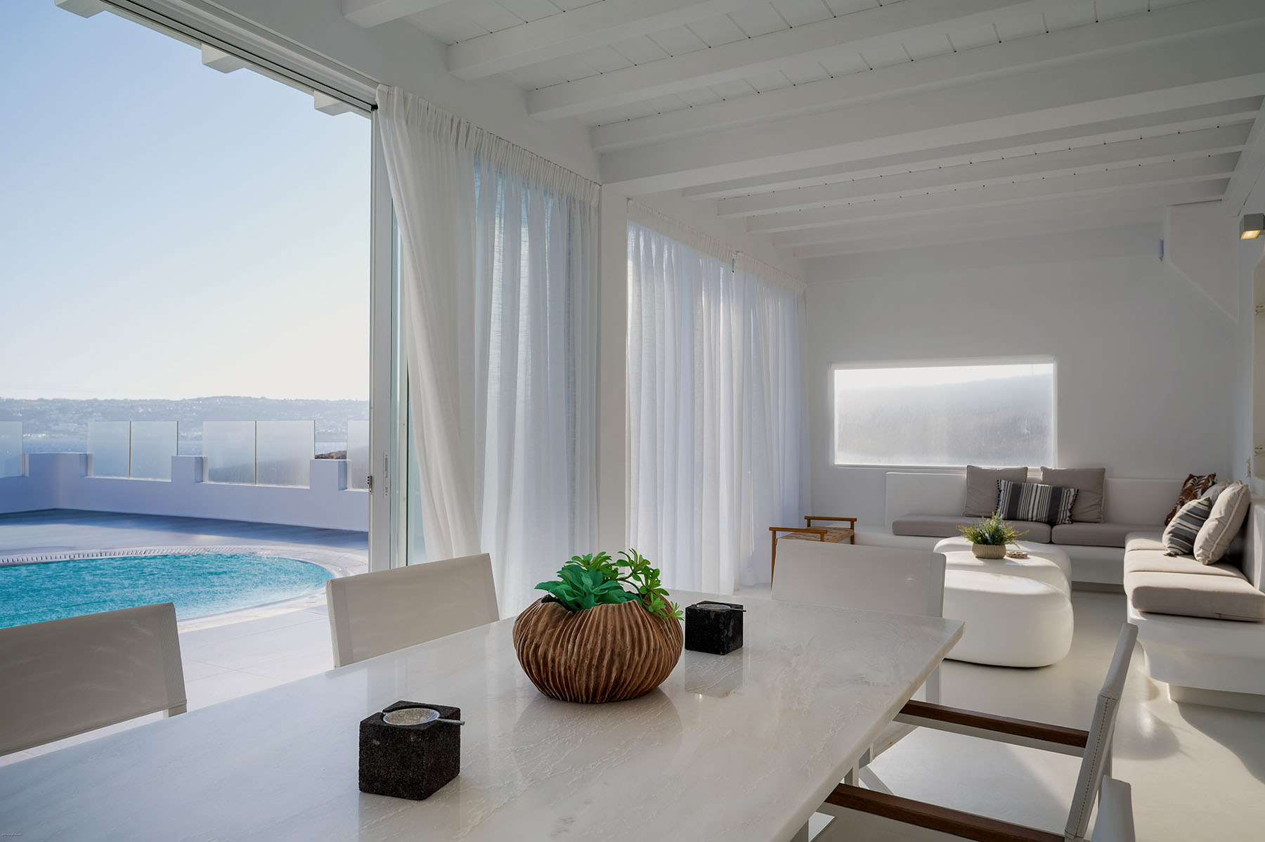 Villa living area opening onto a pool